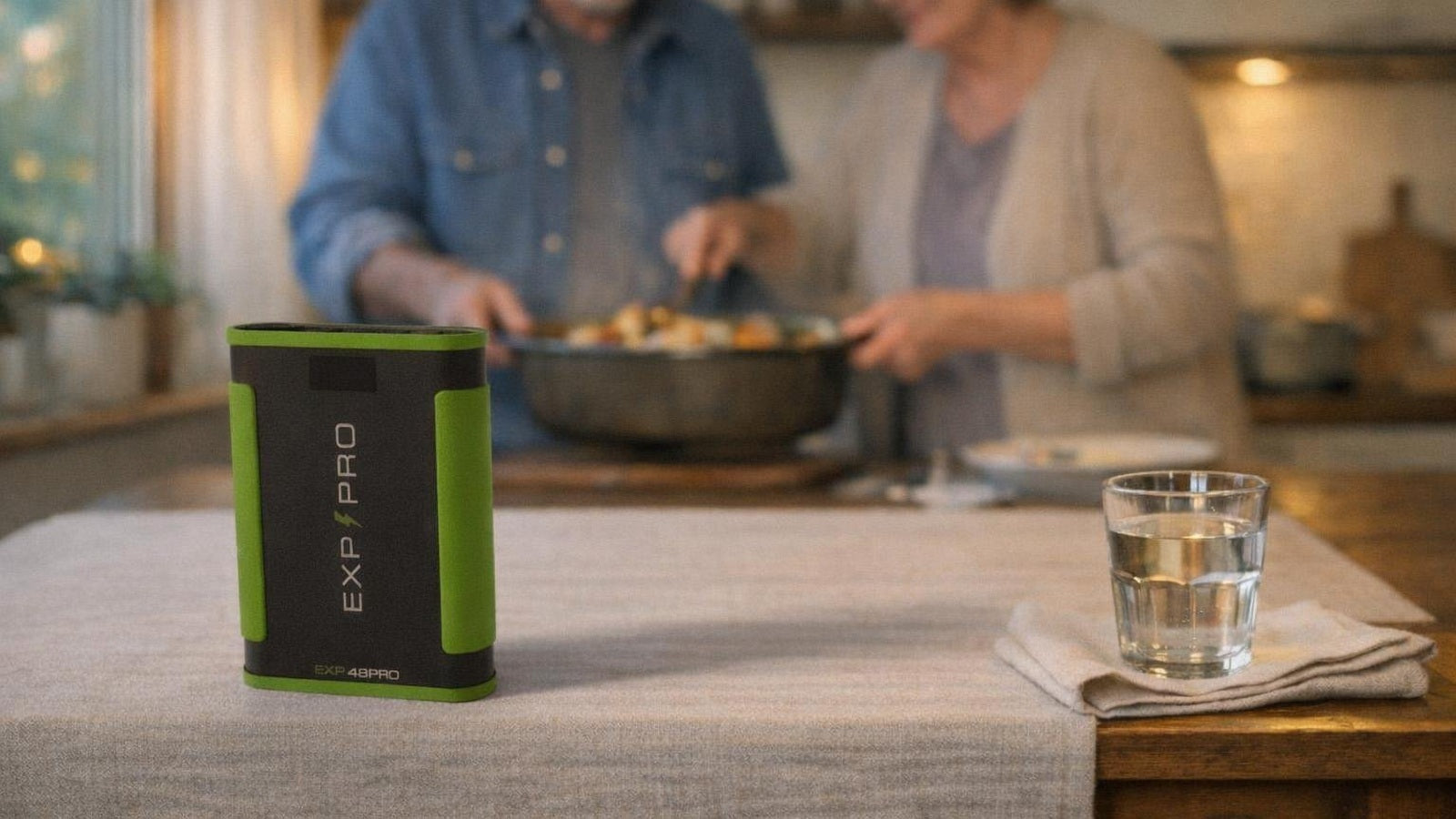 EXP48PRO APEX CPAP battery standing on a kitchen dinner table while an older couple serves dinner