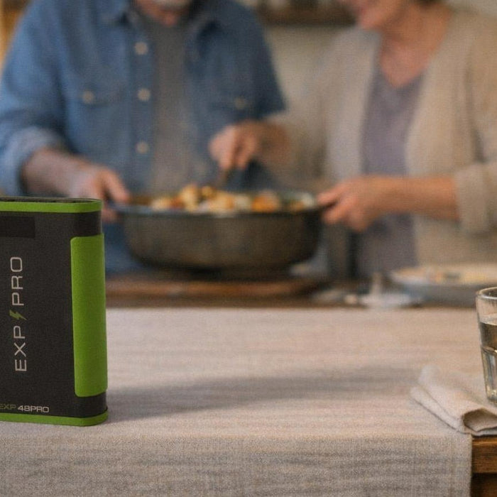 EXP48PRO APEX CPAP battery standing on a kitchen dinner table while an older couple serves dinner